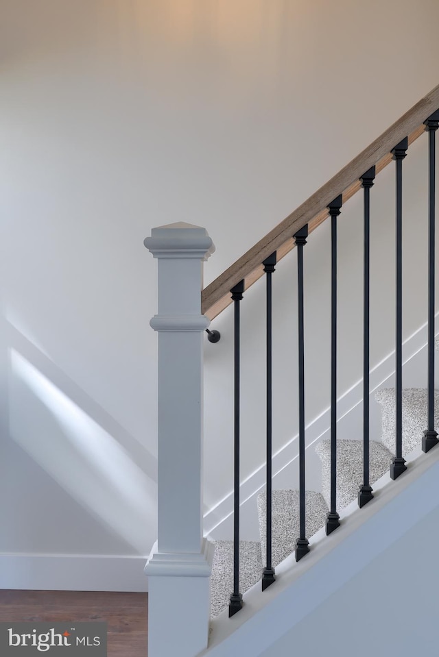 stairs with wood finished floors and baseboards