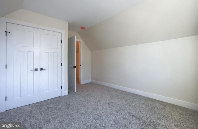 additional living space featuring lofted ceiling, baseboards, and carpet flooring