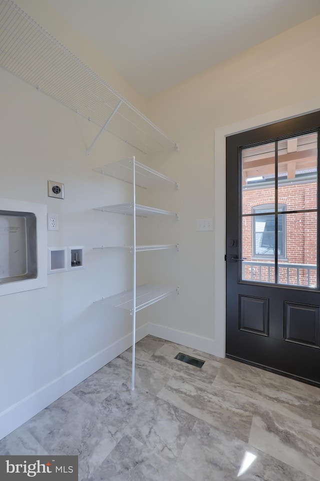 washroom with laundry area, visible vents, hookup for a washing machine, and baseboards