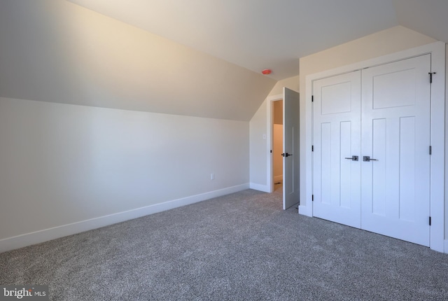 bonus room with lofted ceiling, carpet, and baseboards