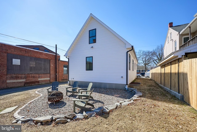 back of property with a fire pit