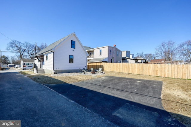 view of home's exterior with entry steps, a patio area, and fence