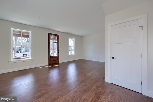 foyer with baseboards, dark wood finished floors, visible vents, and a healthy amount of sunlight