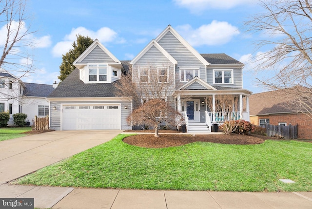 view of front of house featuring covered porch, concrete driveway, an attached garage, a front yard, and fence