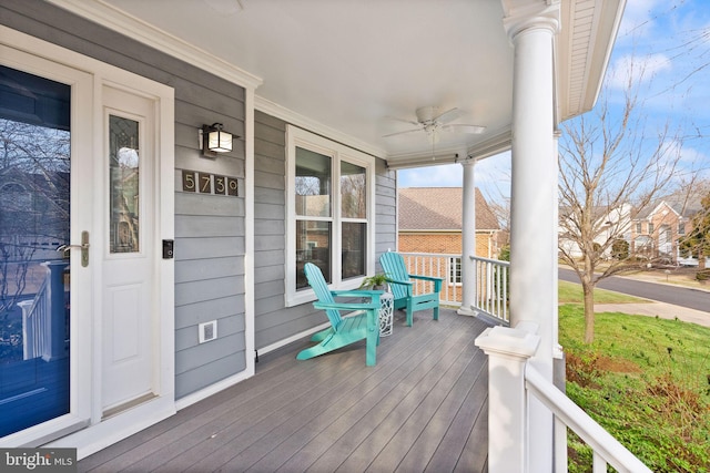 wooden terrace with a porch and a ceiling fan