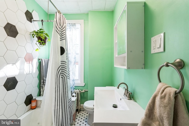 bathroom with toilet, a sink, and shower / tub combo with curtain