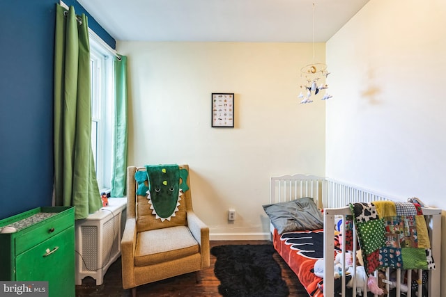 bedroom with baseboards and wood finished floors