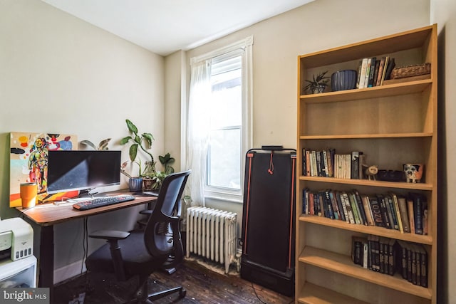 office area with dark wood finished floors and radiator