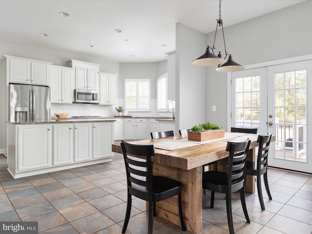 dining area with recessed lighting and french doors