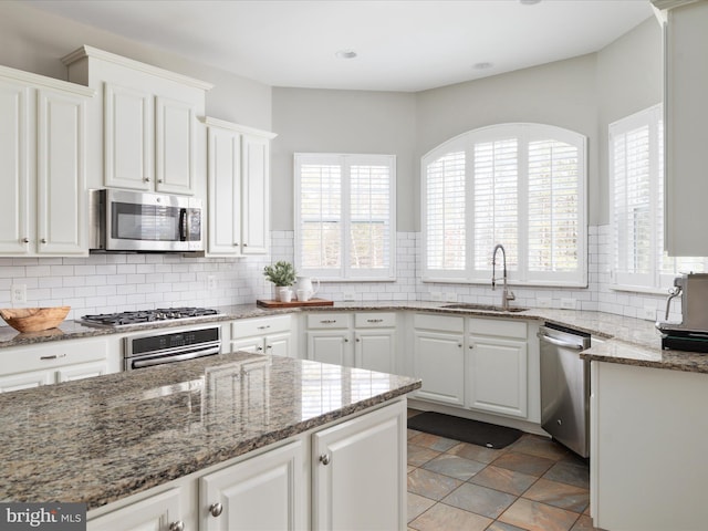 kitchen with white cabinetry, stainless steel appliances, and decorative backsplash