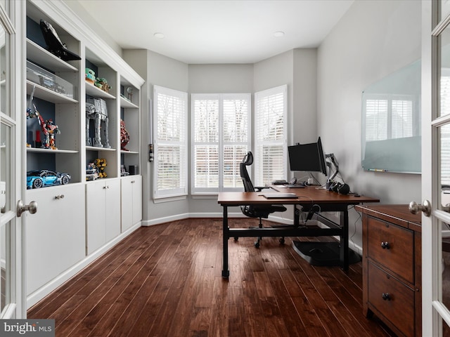 office space with baseboards and dark wood finished floors