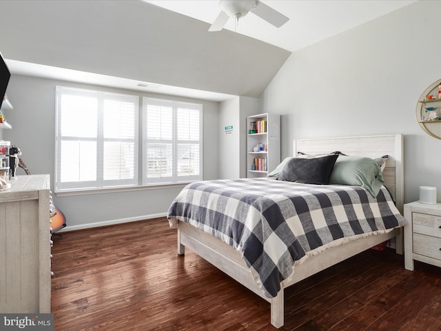 bedroom featuring a ceiling fan, baseboards, vaulted ceiling, and wood finished floors