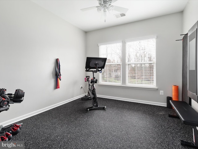 exercise room featuring a ceiling fan and baseboards