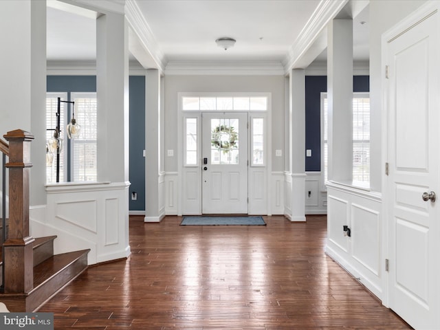 entryway with a healthy amount of sunlight, dark wood-style floors, and crown molding