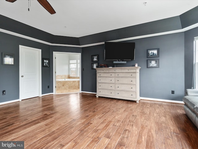 unfurnished living room with light wood-style flooring, baseboards, and a ceiling fan