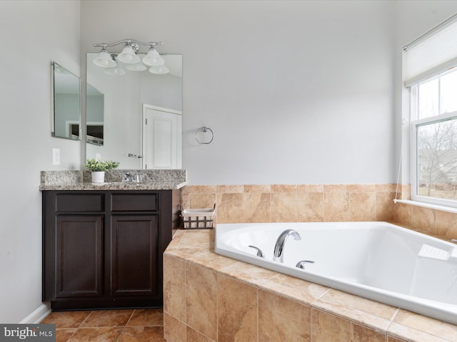 bathroom featuring tile patterned flooring, vanity, and a bath