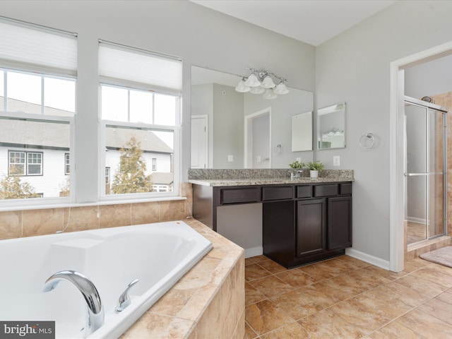 full bath featuring a garden tub, vanity, baseboards, a shower stall, and tile patterned floors