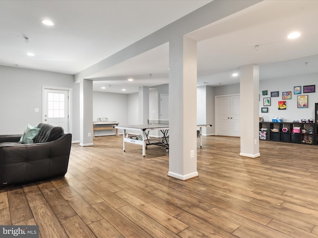 living room with baseboards, wood finished floors, and recessed lighting