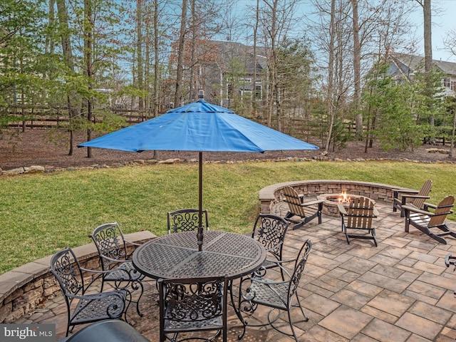 view of patio / terrace with outdoor dining area and a fire pit