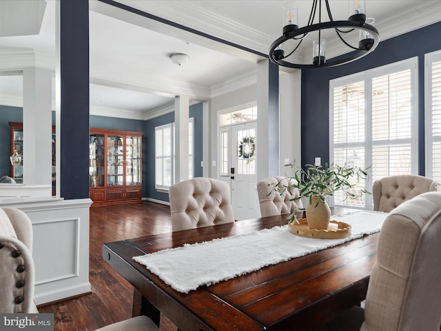 dining area featuring dark wood-style floors, french doors, a notable chandelier, and crown molding