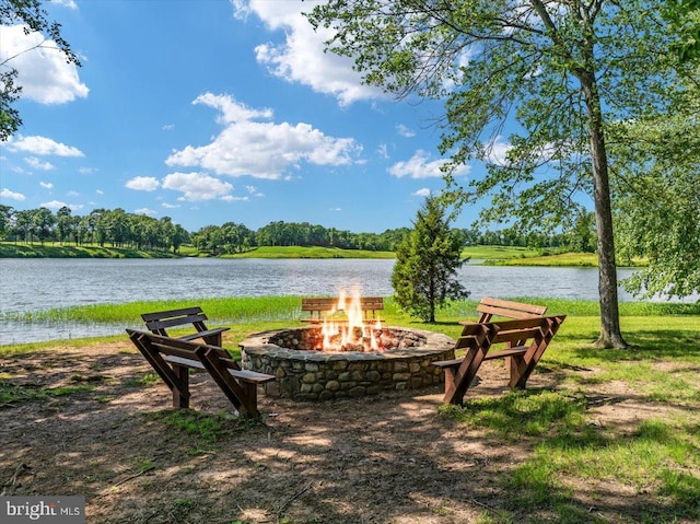 view of yard featuring an outdoor fire pit and a water view