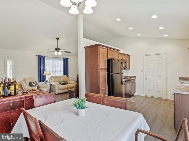 dining room with light wood-type flooring, ceiling fan, recessed lighting, and lofted ceiling