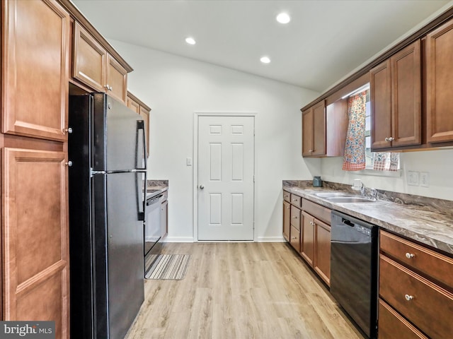 kitchen featuring recessed lighting, light wood-style floors, vaulted ceiling, a sink, and black appliances