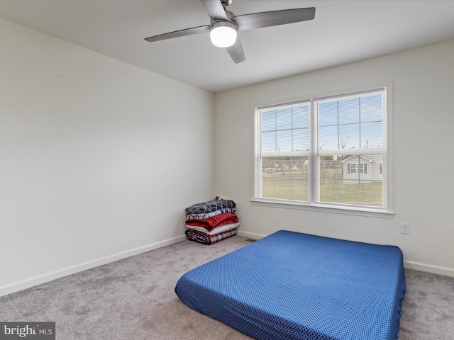 bedroom with carpet floors, a ceiling fan, and baseboards