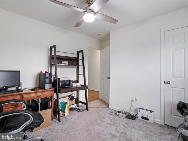 home office with baseboards, a ceiling fan, and carpet flooring