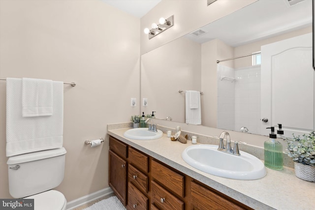 20769 Brunswick Ln, Millsboro, DE 19966 - bathroom with toilet, a shower, double vanity, and baseboards
