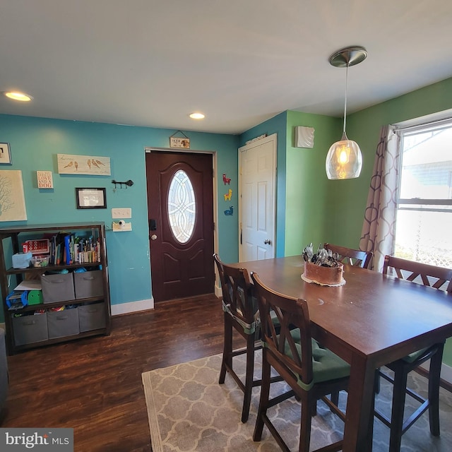 dining space with baseboards, dark wood finished floors, and recessed lighting