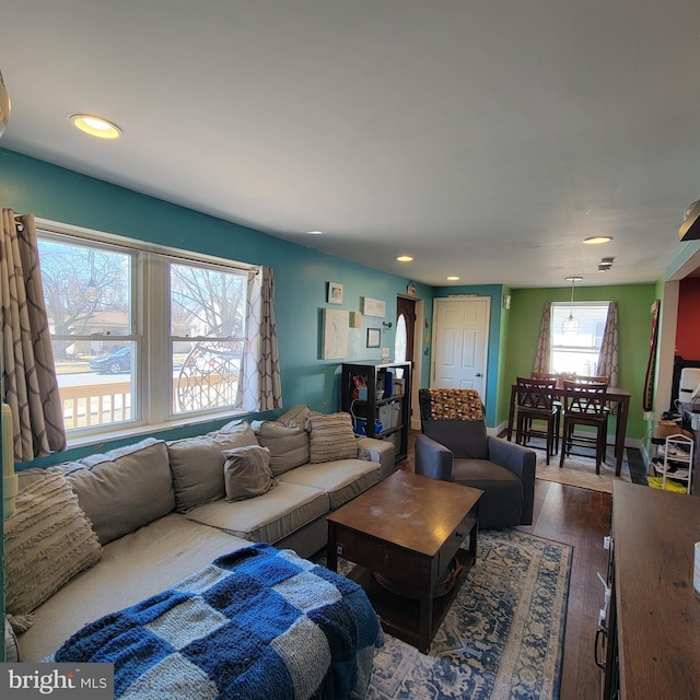 living area with dark wood-style floors and recessed lighting