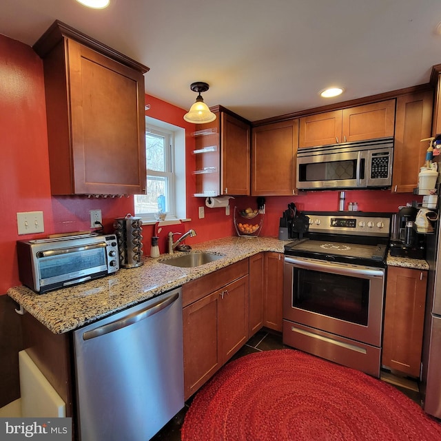 kitchen featuring recessed lighting, a toaster, a sink, appliances with stainless steel finishes, and light stone countertops