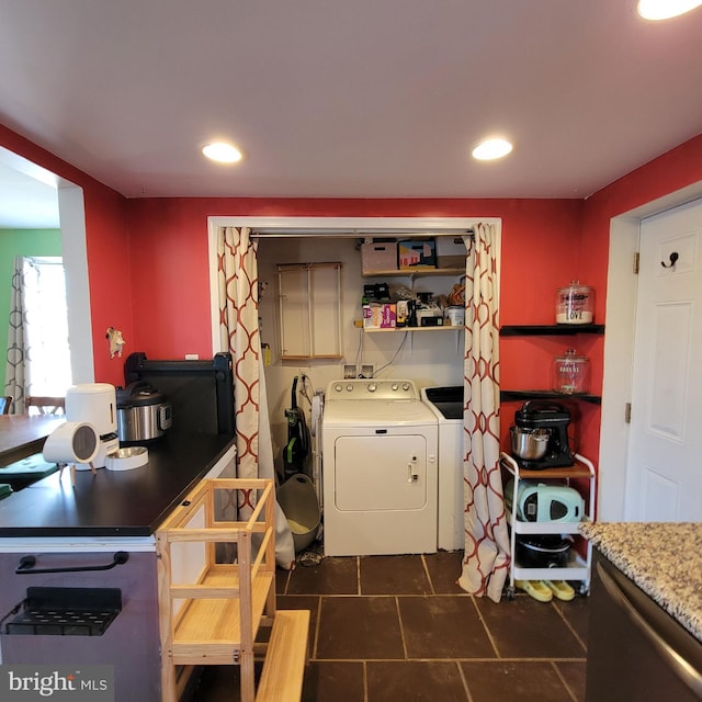 kitchen with open shelves, dark tile patterned floors, washer and clothes dryer, and recessed lighting