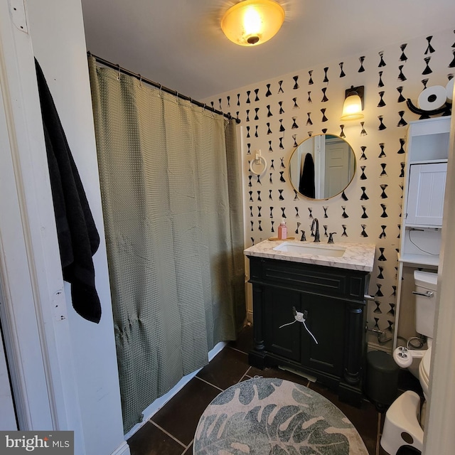 bathroom with a shower with shower curtain, vanity, toilet, and tile patterned floors