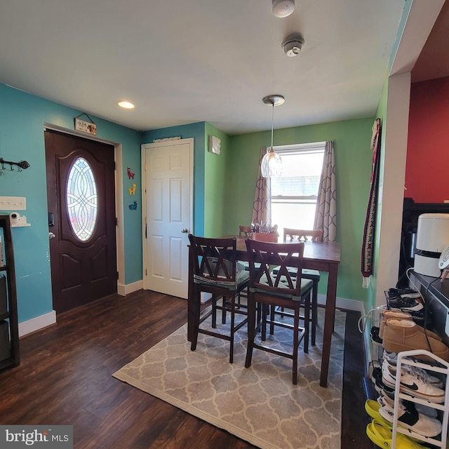 dining area with baseboards and wood finished floors