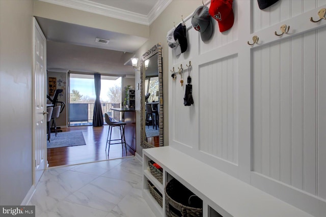 mudroom featuring visible vents, baseboards, marble finish floor, and ornamental molding