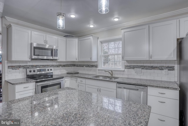 kitchen with stainless steel appliances, crown molding, a sink, and white cabinetry