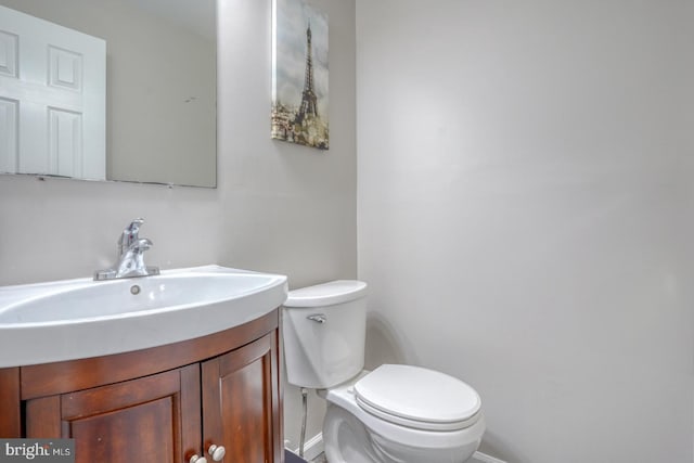 half bath with vanity and toilet