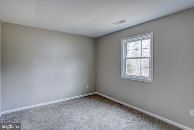 carpeted empty room with baseboards and visible vents