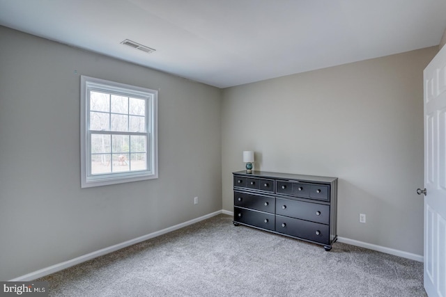 unfurnished bedroom featuring baseboards, visible vents, and carpet flooring