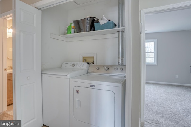 washroom with laundry area, light colored carpet, baseboards, and separate washer and dryer