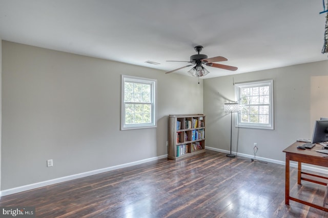 office area with a ceiling fan, visible vents, baseboards, and wood finished floors