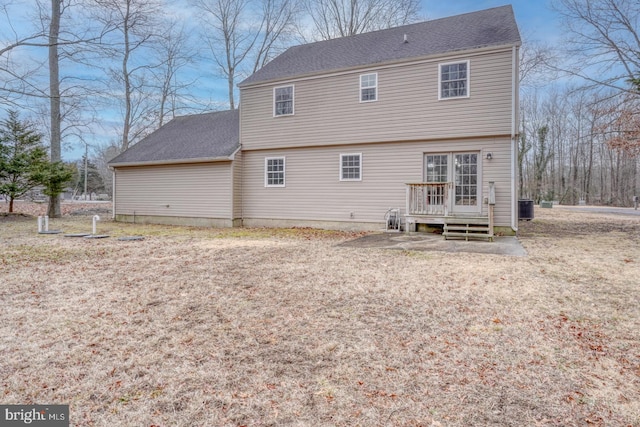 rear view of property featuring a deck, central AC, and a shingled roof