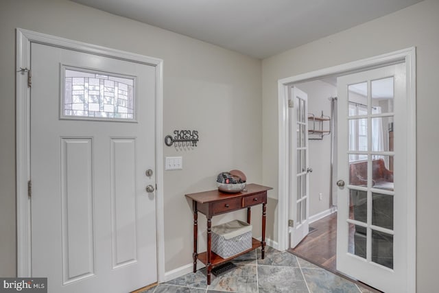 entrance foyer featuring a healthy amount of sunlight, baseboards, and french doors