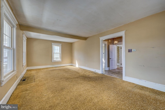 carpeted spare room with baseboards