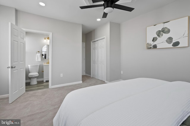 carpeted bedroom with baseboards, ceiling fan, ensuite bathroom, a closet, and recessed lighting