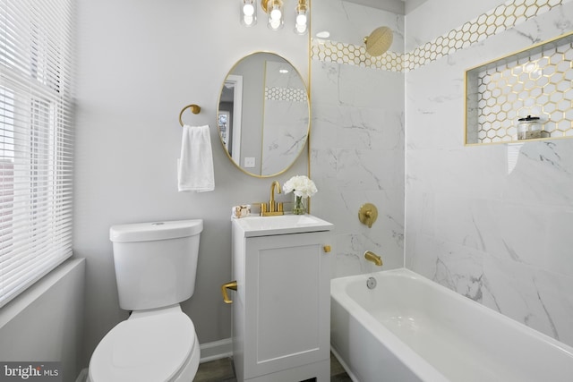 bathroom with bathing tub / shower combination, vanity, toilet, and baseboards