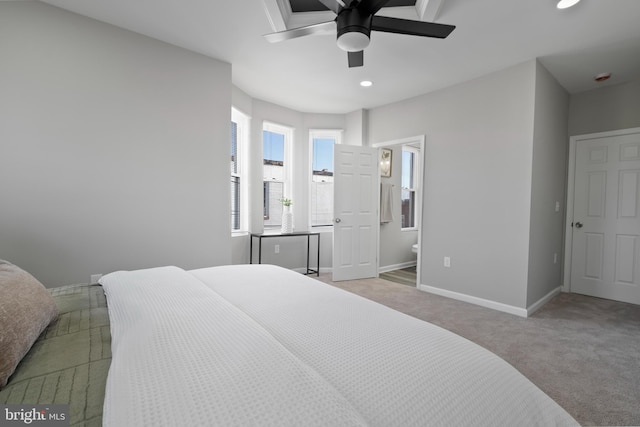 bedroom featuring carpet floors, connected bathroom, ceiling fan, and baseboards