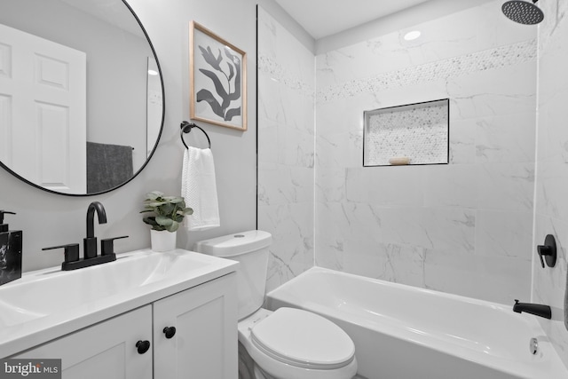 bathroom with bathing tub / shower combination, vanity, and toilet